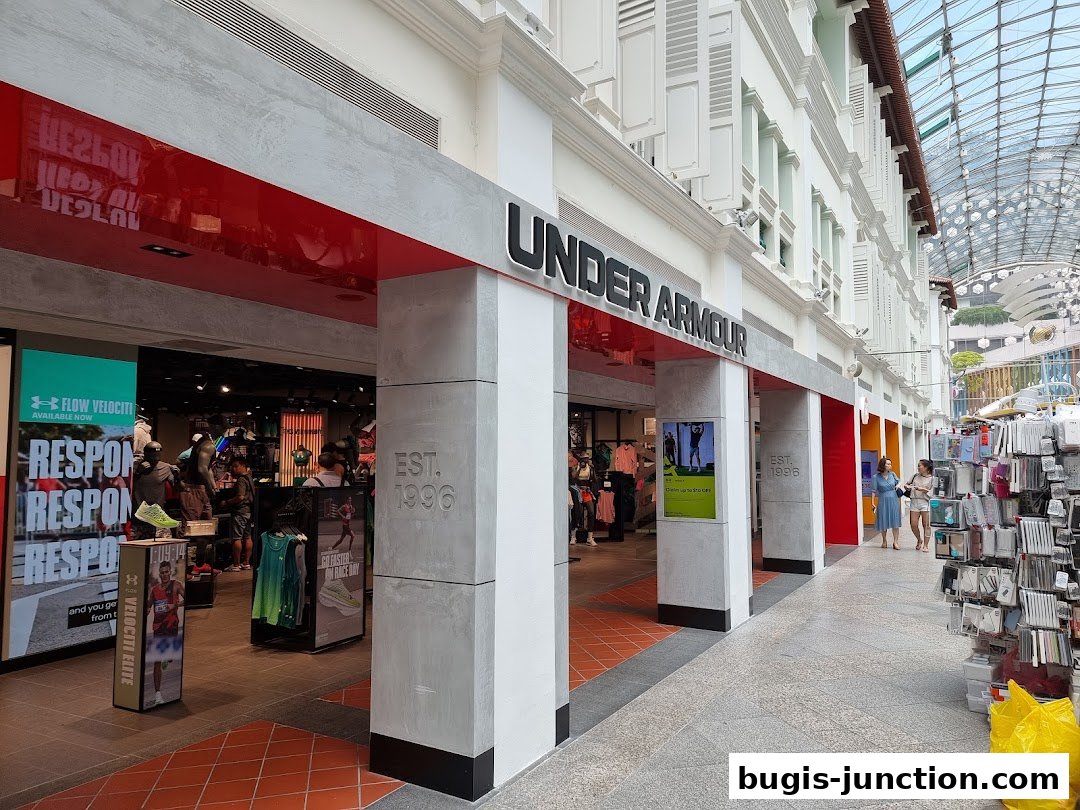 The entrance of the Under Armour store at Bugis Junction, showcasing sportswear and promotions.