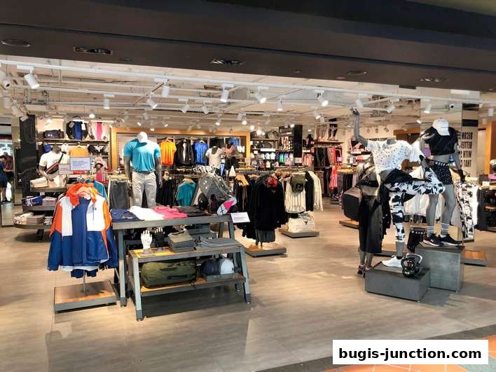 Interior view of an Under Armour store showcasing athletic apparel on mannequins and racks.