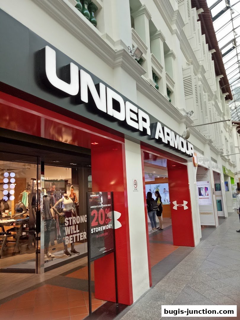 The Under Armour store front with its prominent logo and a sale sign.