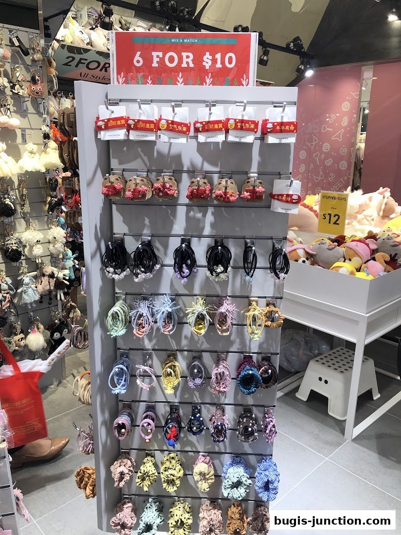 A display of hair accessories and stuffed toys with a promotional sign.