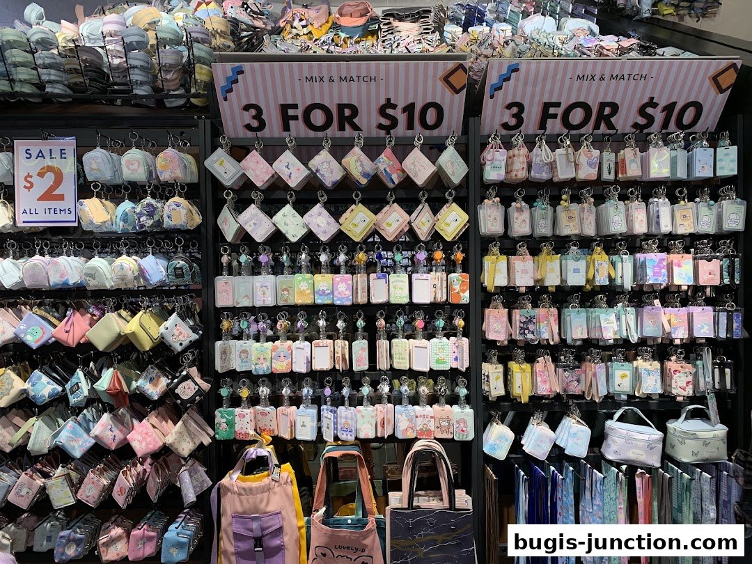 A shop display filled with colorful pouches, keychains, and bags, featuring sale signs.
