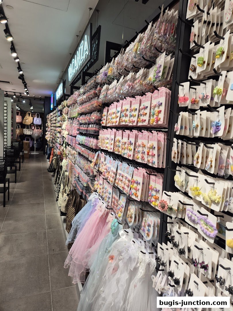 A shop interior filled with colorful hair accessories and dresses, with the shop name 'Vacanza' visible.