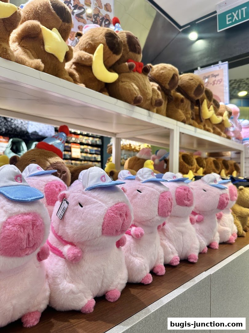 A display of cute plush toys, including pink pigs with caps and brown bears with party hats.