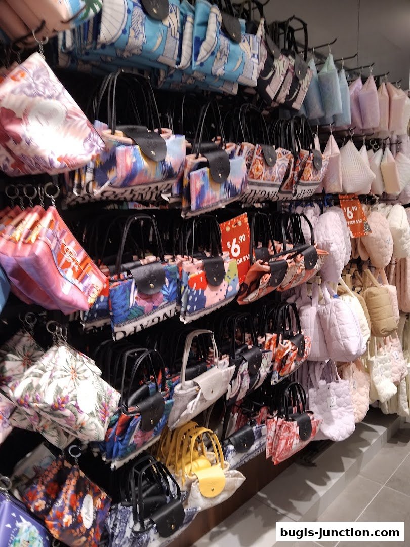 A wall display of colorful and patterned handbags and pouches.