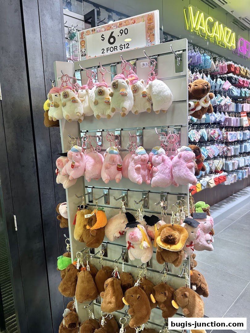 A display of cute plush keychains, including sheep and pigs, with a price tag visible.