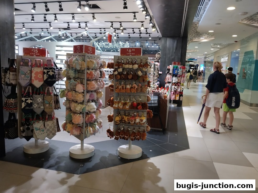 A retail shop displaying various accessories like bags and plush keychains, with shoppers in the background.