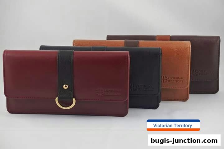 A display of four leather clutch bags in various colors: burgundy, black, tan, and brown.