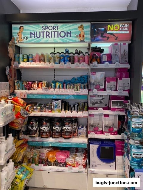 Shelves stocked with sport nutrition products, supplements, and health accessories.
