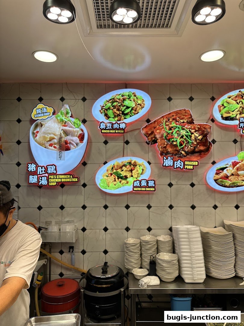 A wall display of various Chinese dishes with their names and images.