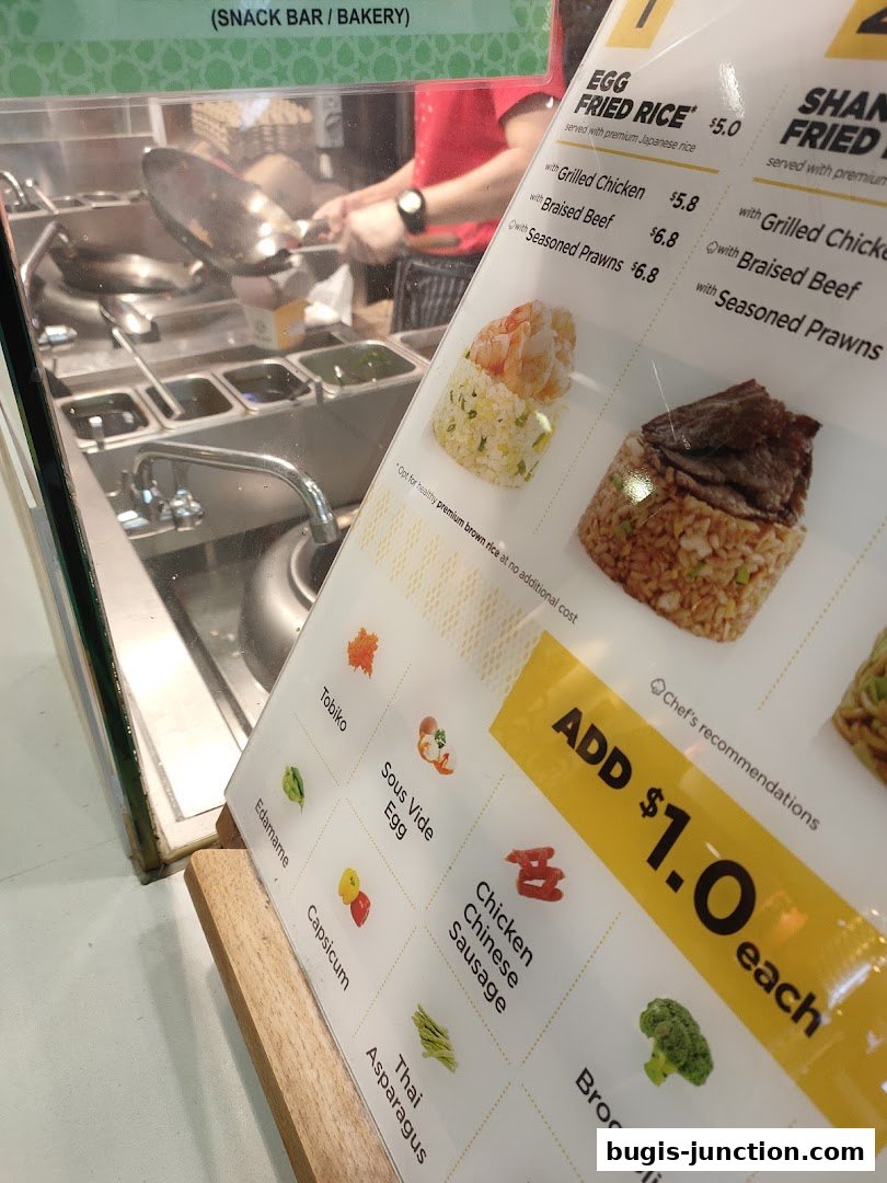 A menu board showing fried rice options and add-on ingredients at Wok Hey.