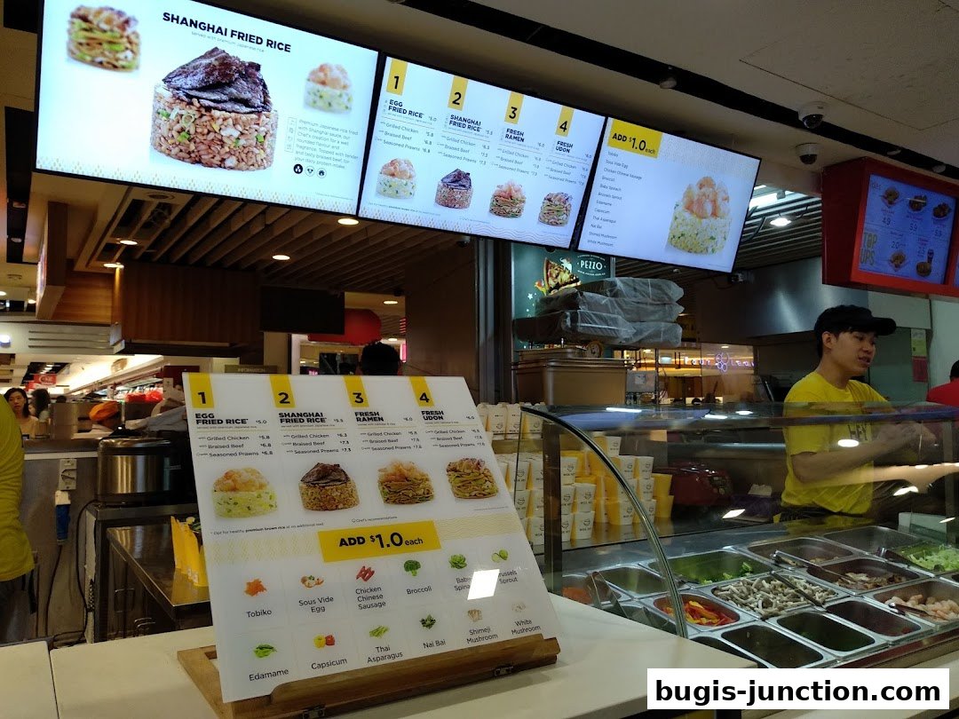 A menu board and display of ingredients at a Wok Hey restaurant.