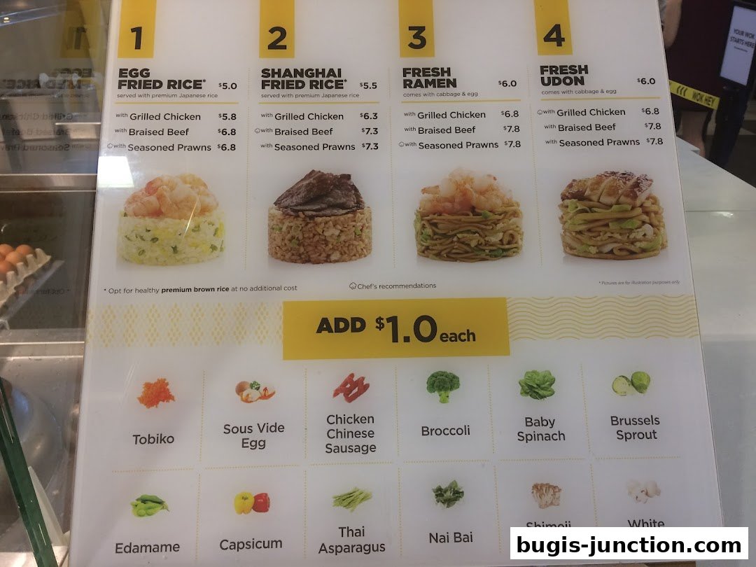 A menu board displaying various rice, ramen, and udon dishes with add-on options.