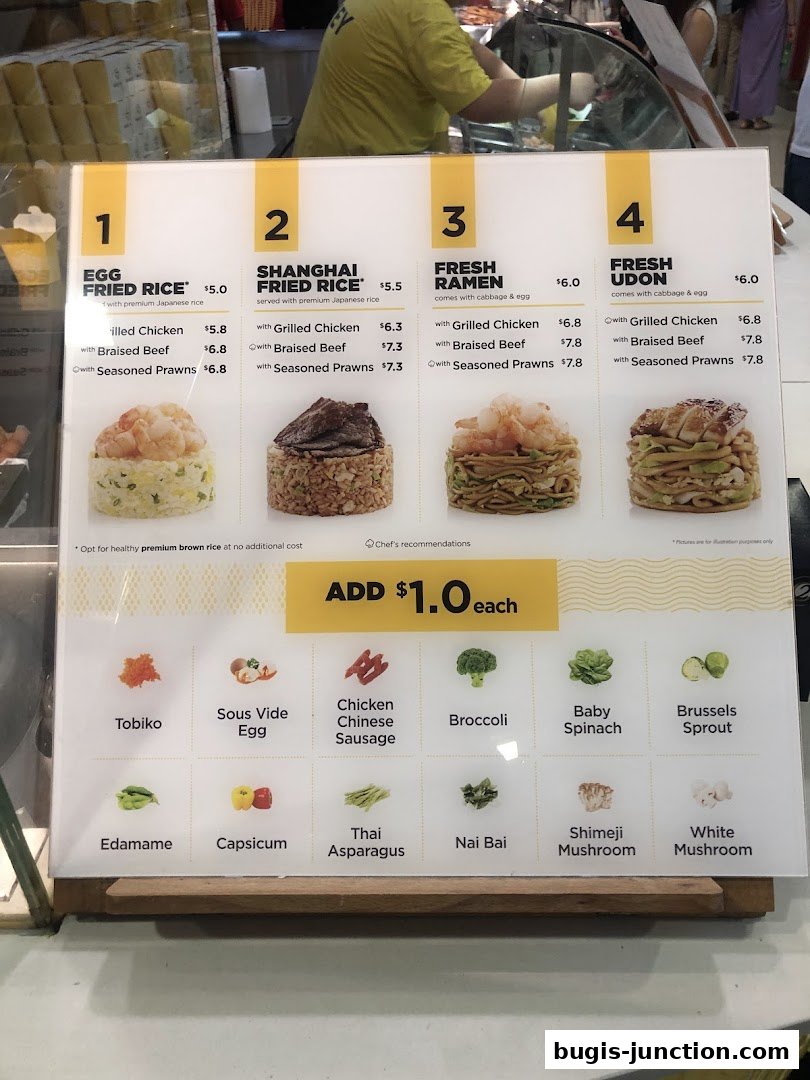 A menu board displaying various rice, ramen, and udon dishes with customizable toppings.