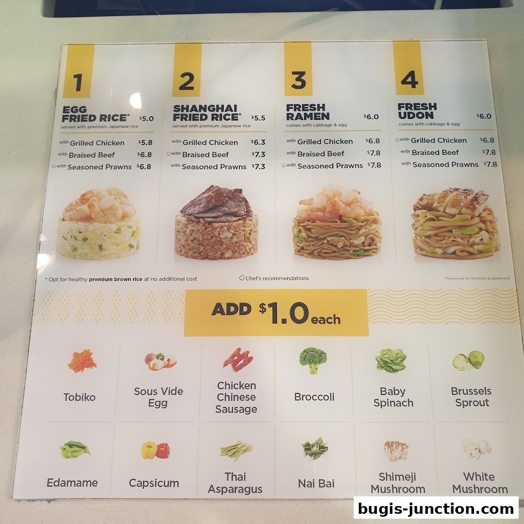 A menu board displaying various fried rice, ramen, and udon dishes with add-on options.