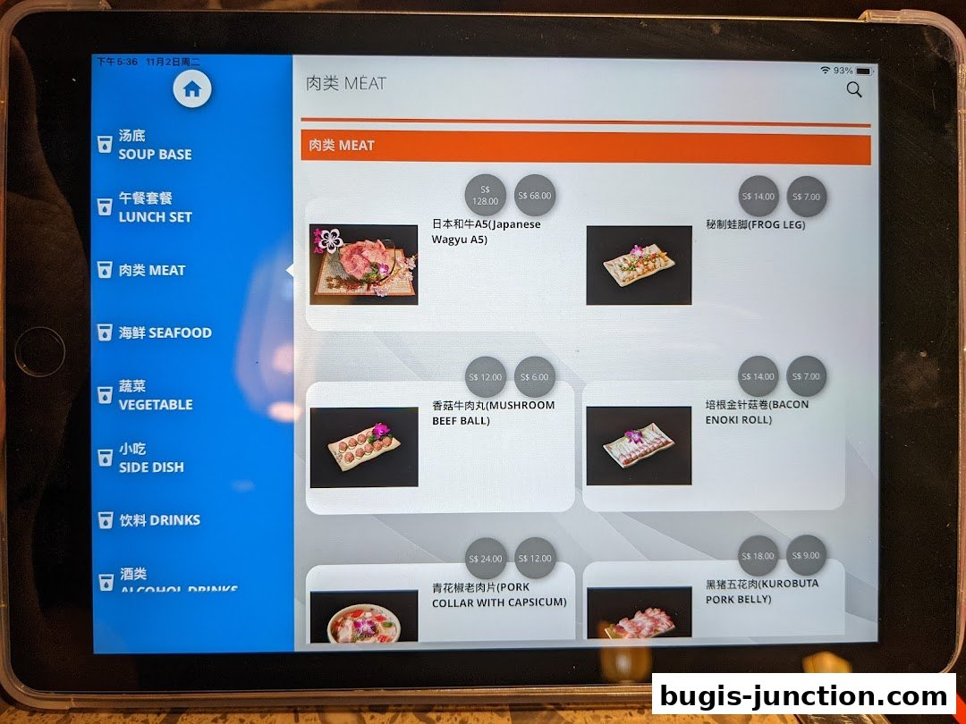 A tablet displays a digital menu for Xiao Long Kan Hotpot, showcasing meat dishes.
