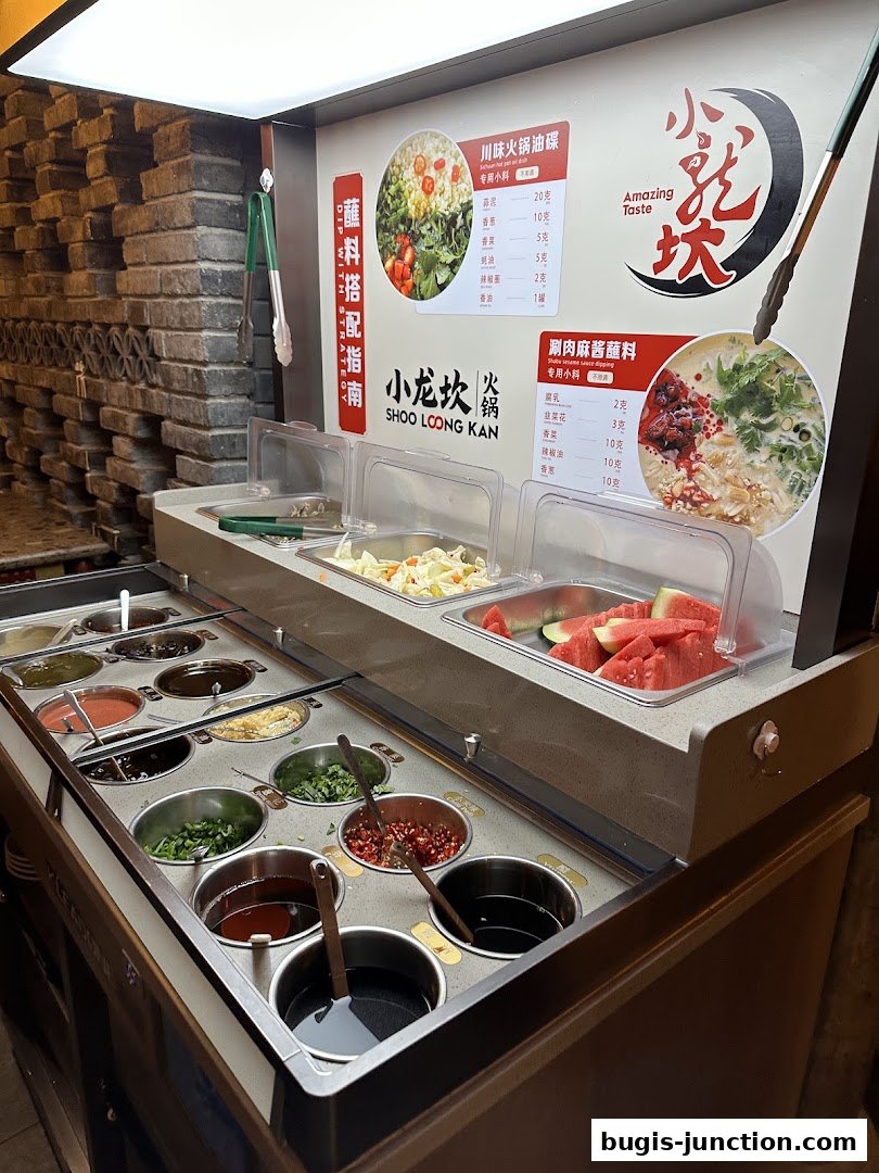 A display of various dipping sauces and ingredients for hotpot at Xiao Long Kan.