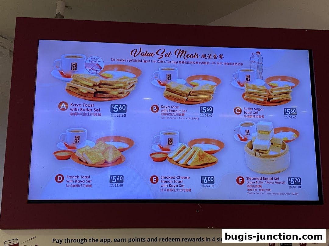 A digital menu board displaying various value set meals from Ya Kun Kaya Toast.