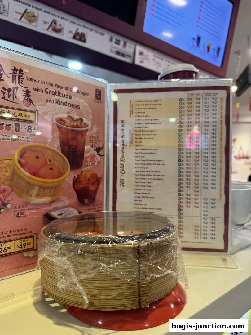 A close-up of a menu board at Ya Kun Kaya Toast, featuring beverages and food items.
