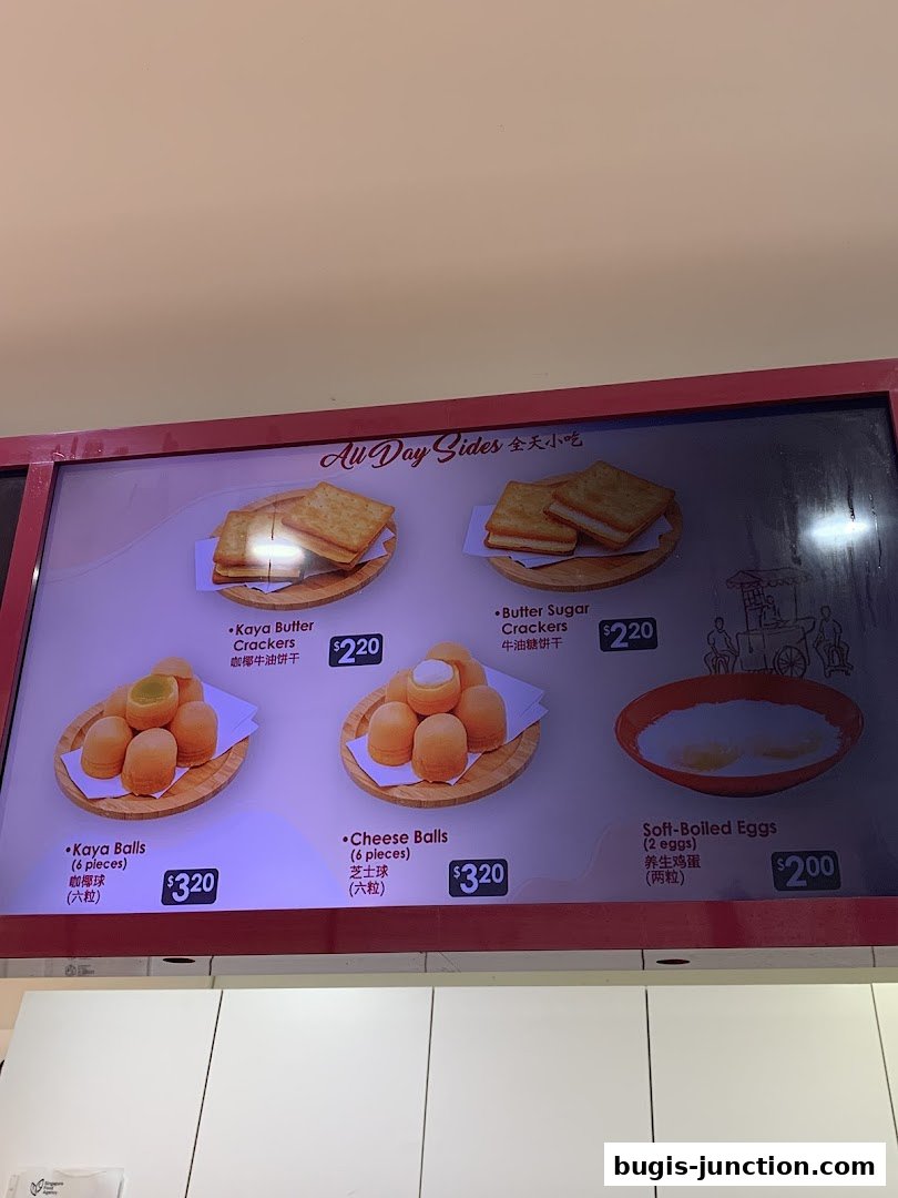 A menu board displaying various snacks and soft-boiled eggs from Ya Kun Kaya Toast.