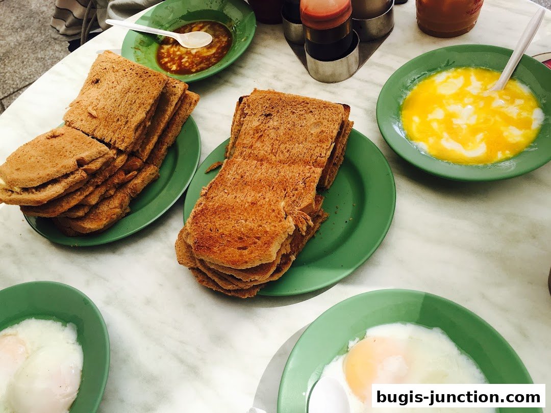 A table laden with Ya Kun Kaya Toast's signature kaya toast and soft-boiled eggs.