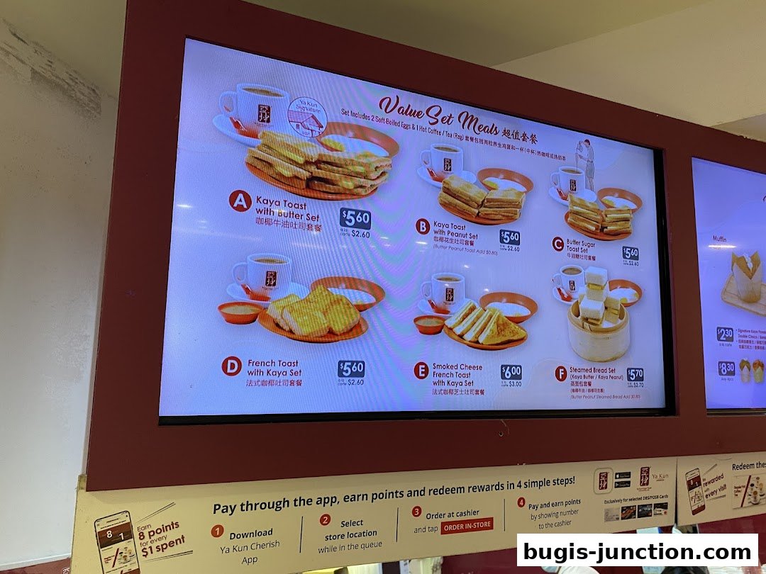 A digital menu board displaying various value set meals from Ya Kun Kaya Toast.