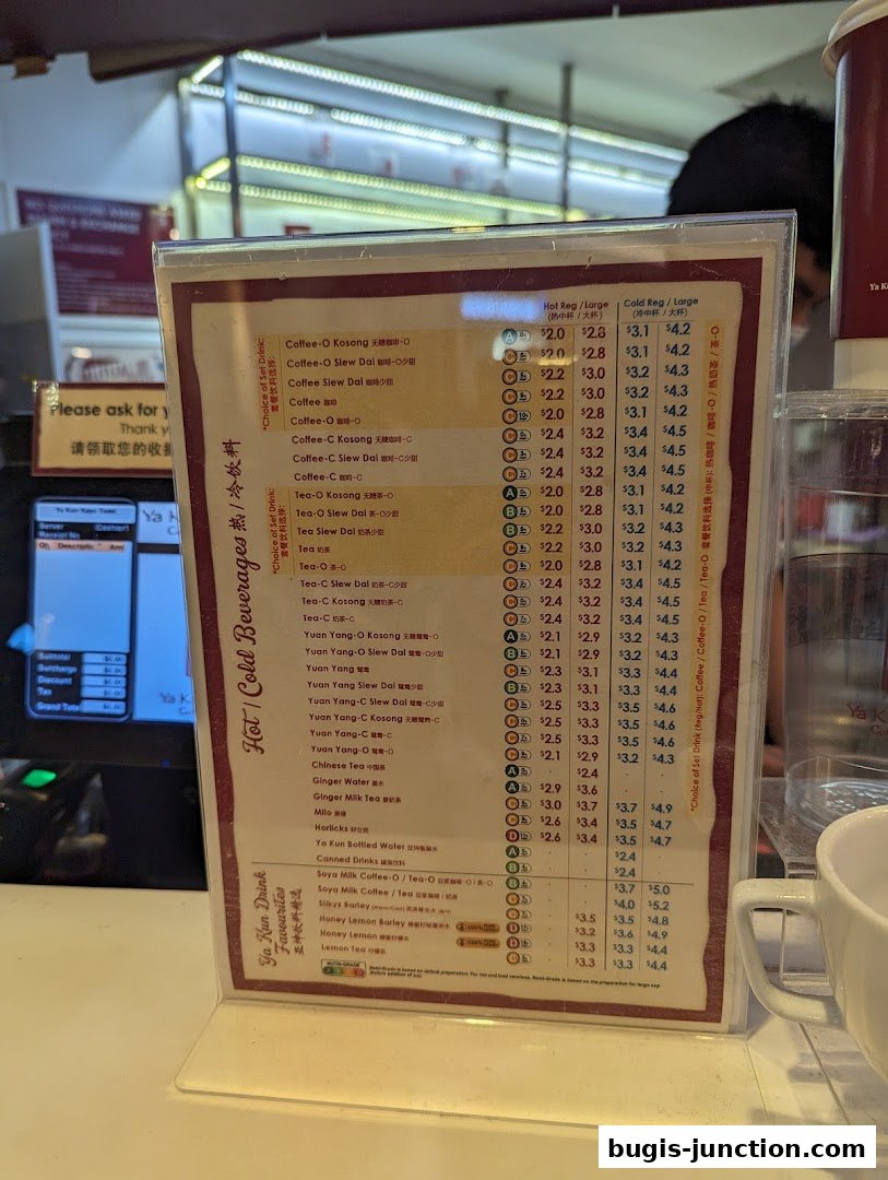 A menu board displaying various hot and cold beverages with prices at Ya Kun Kaya Toast.