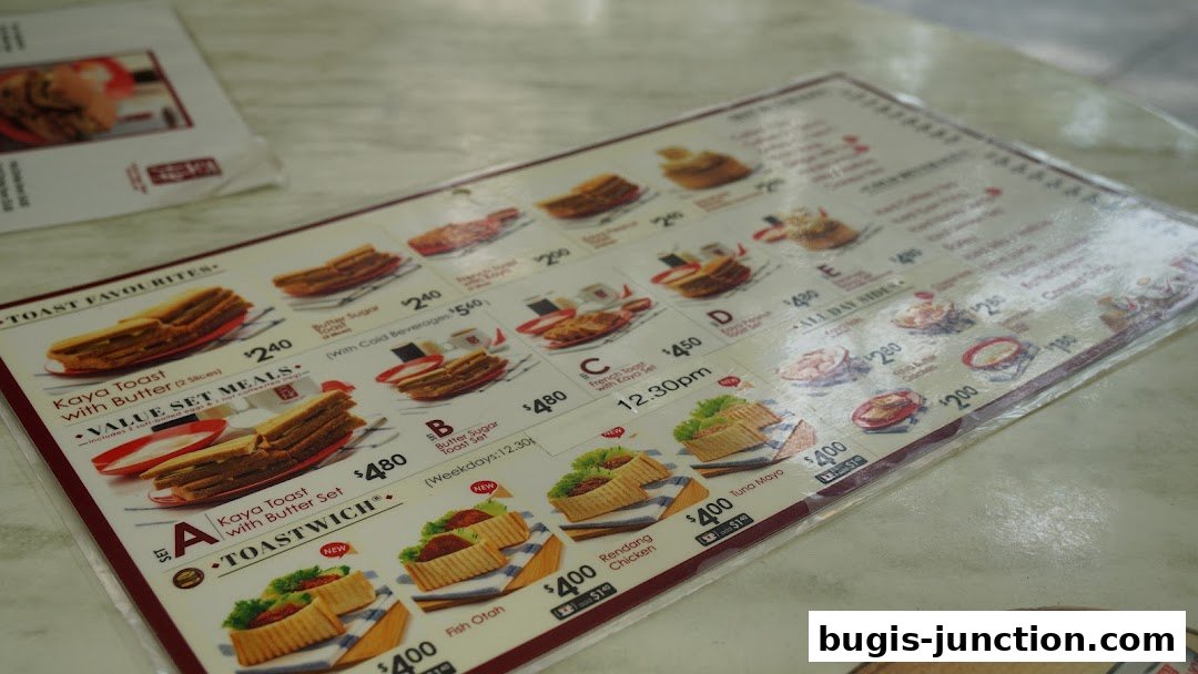 A menu from Ya Kun Kaya Toast featuring various toast sets and side dishes with prices.