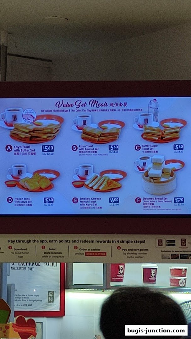 A digital menu board displaying various value set meals from Ya Kun Kaya Toast.