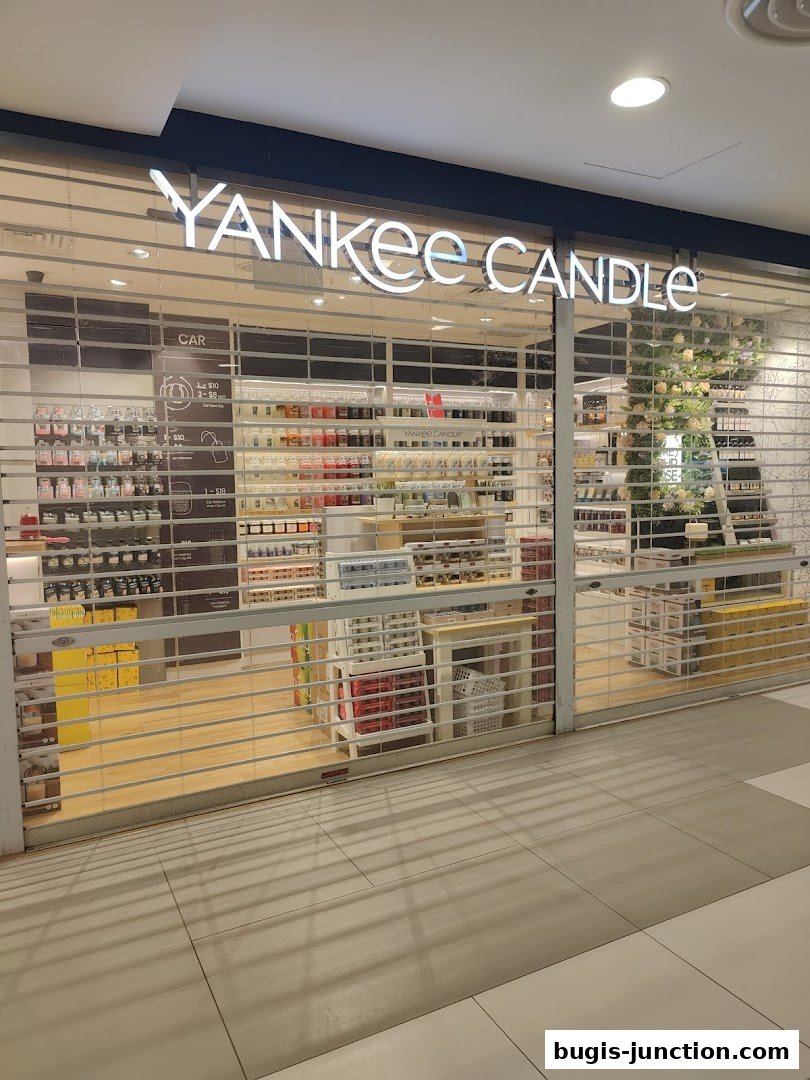 The Yankee Candle store front with its signature logo and shelves stocked with candles.