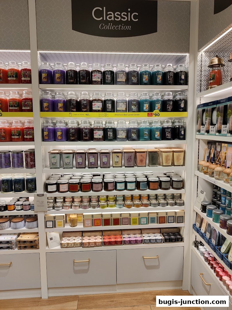 A wide selection of Yankee Candles in various sizes and scents displayed on shelves.