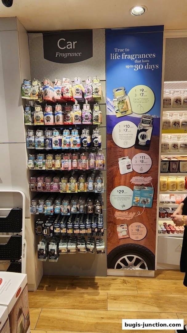 A display of Yankee Candle car fragrances and promotional offers.