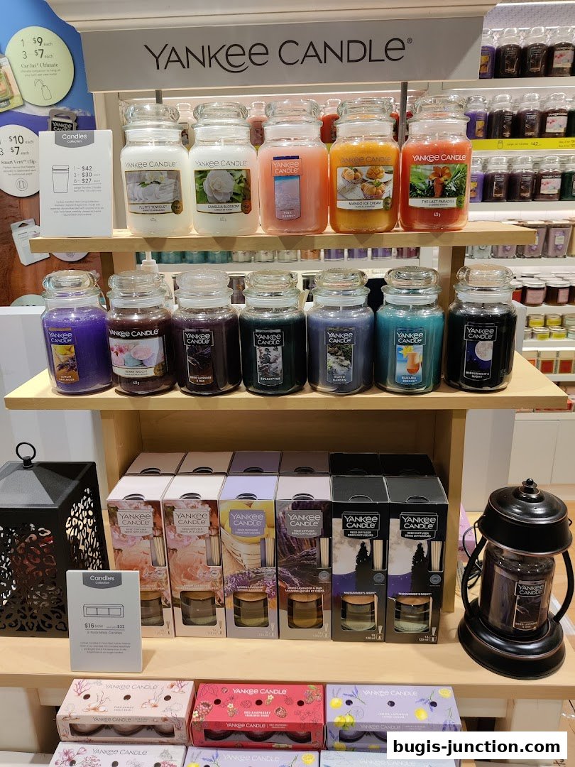 A display of various Yankee Candle products, including large jars and reed diffusers.