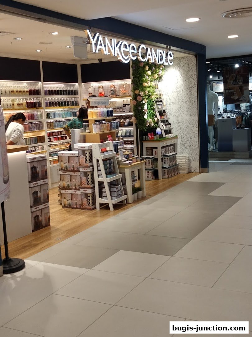 The entrance of a Yankee Candle store with shelves full of candles and decorative displays.
