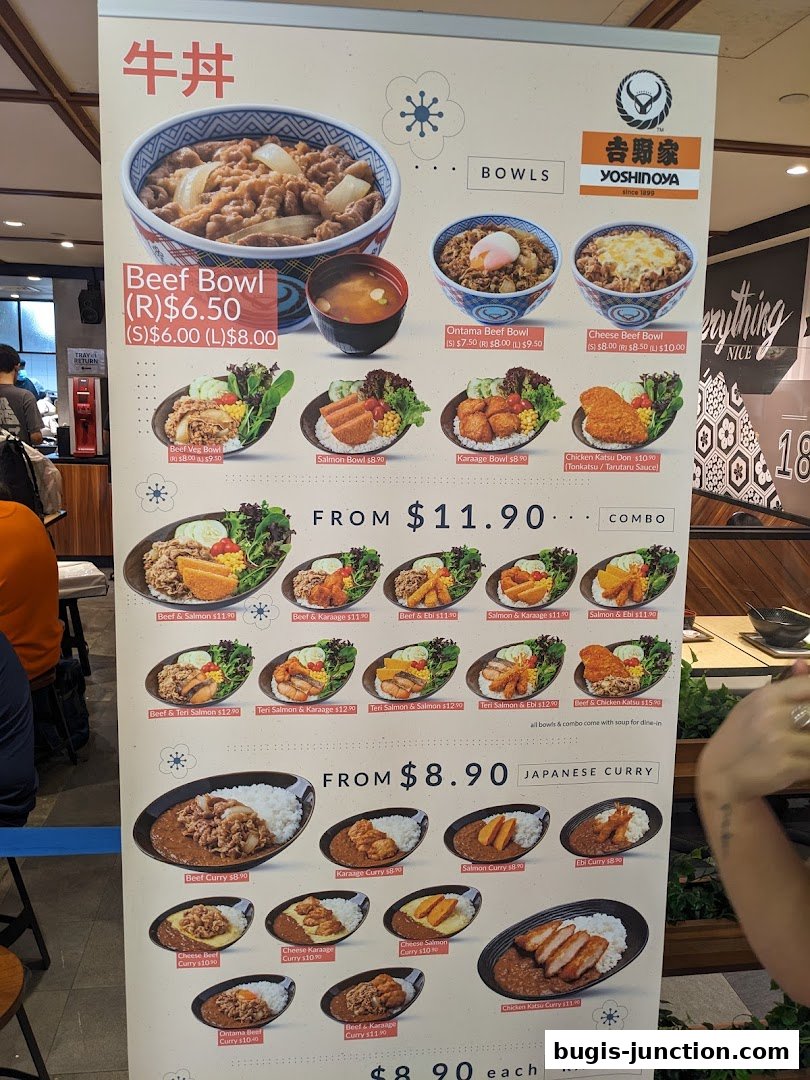A Yoshinoya menu board displaying various beef bowls, combos, and Japanese curry dishes with prices.