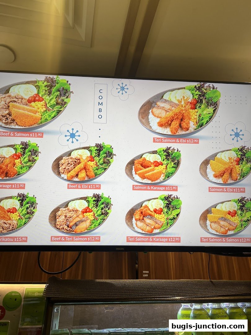 A digital menu board displaying various Japanese combo meals with prices.