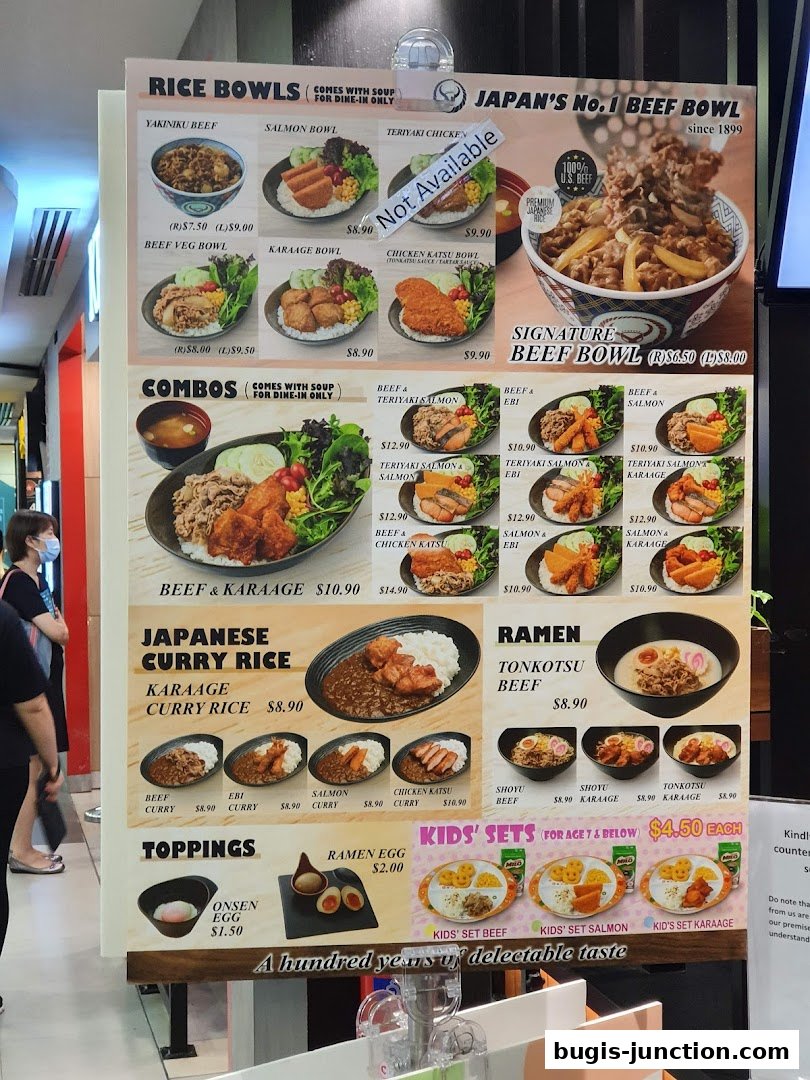 A Yoshinoya menu board displaying various rice bowls, combos, Japanese curry, ramen, and kids' sets.