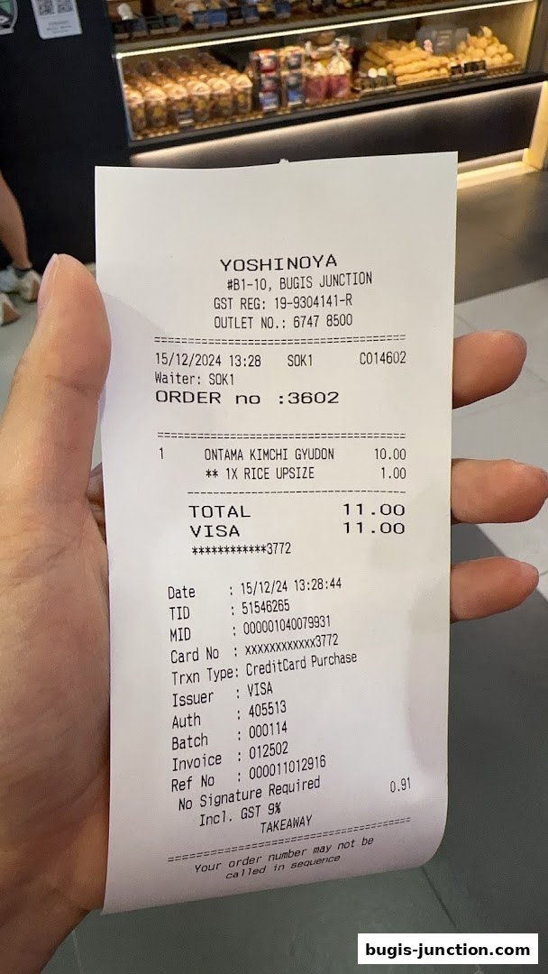 A receipt from Yoshinoya Bugis Junction showing a food order and payment details.
