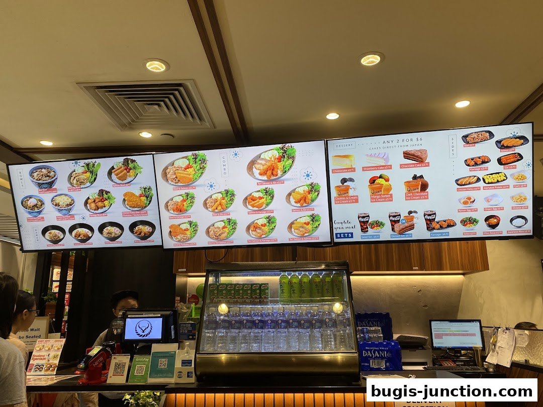 A digital menu board displaying various Japanese food items and desserts.
