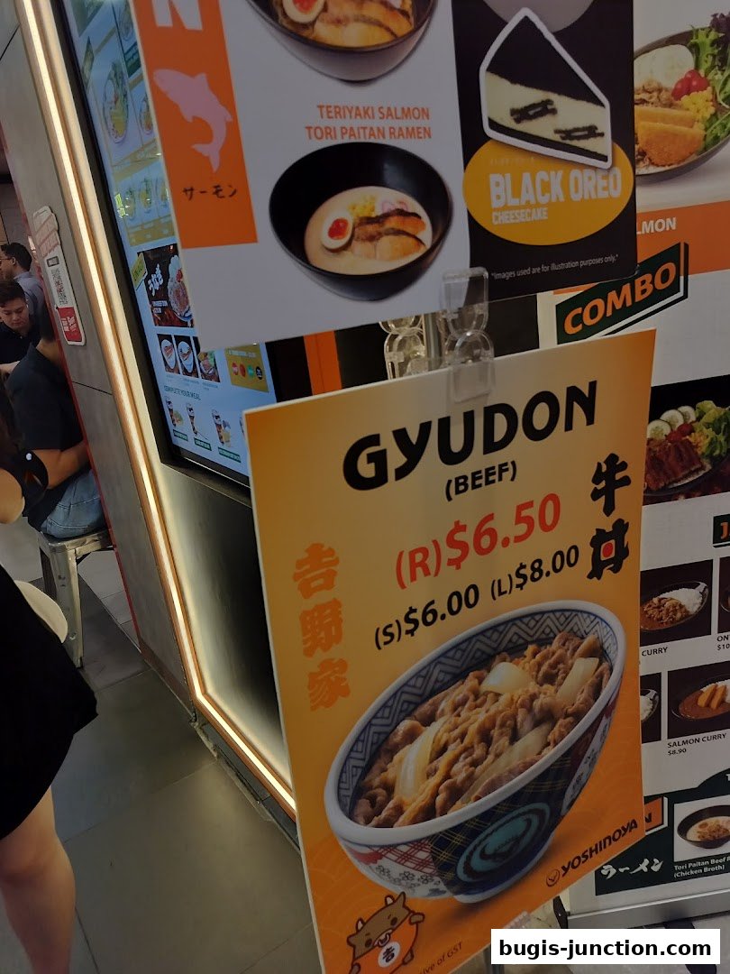 A Yoshinoya menu board featuring Gyudon, ramen, and cheesecake.